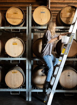 Winemaker Penelope Radburnd tending to French oak barrels in the Radburnd Cellars winery, Hawke's Bay.