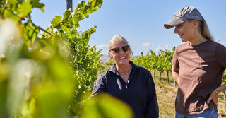 Kate and Penelope Radburnd walking through a Hawke's Bay vineyard before harvest