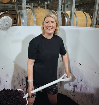 Award-winning winemaker Sara Macdonald working with red grape skins during fermentation at Radburnd Cellars, Hawke's Bay